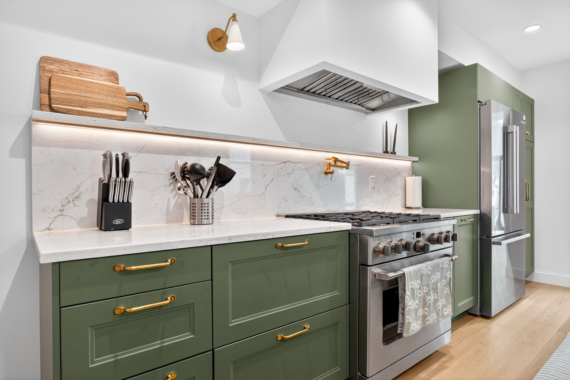 Custom range, marble backsplash, brass pulls and pot filler