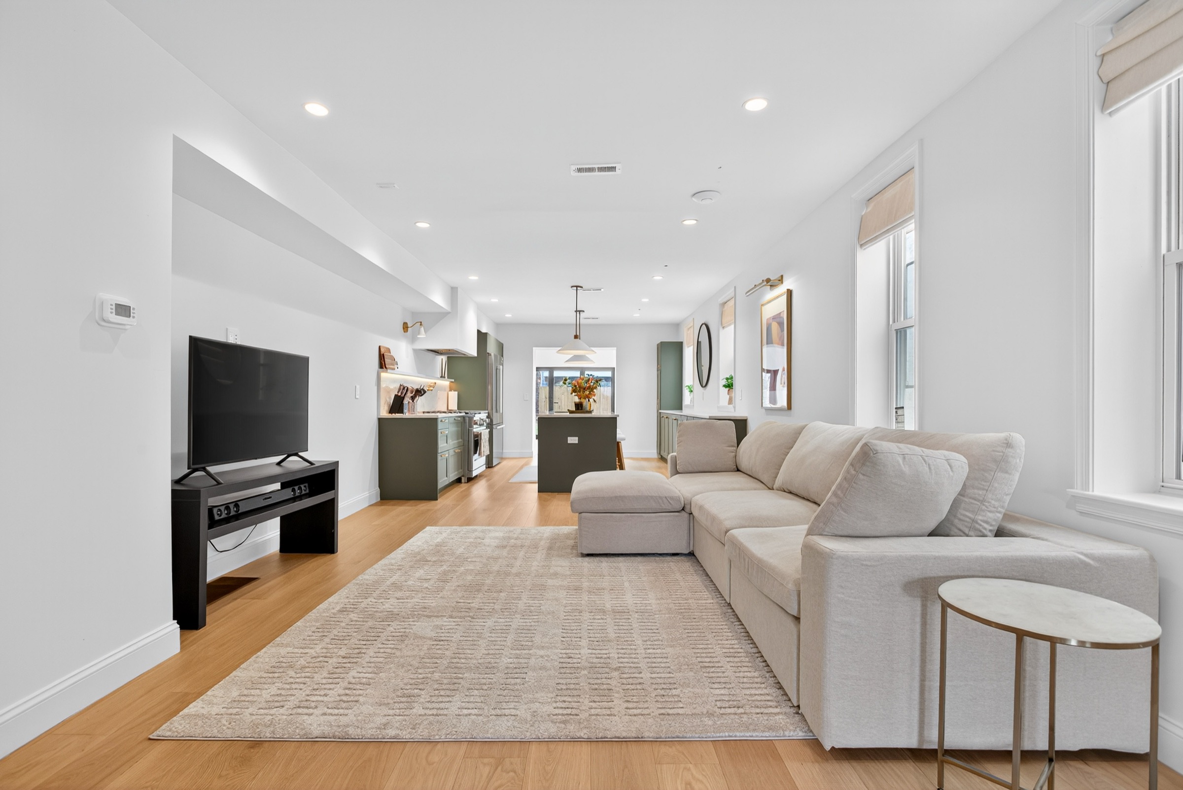 Open-concept first floor — living area flowing into the kitchen at the back